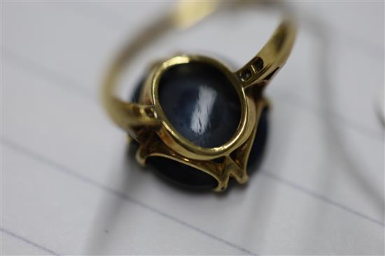 A 1920s 18ct gold, platinum and oval black opal dress ring with diamond set shoulders, size M.